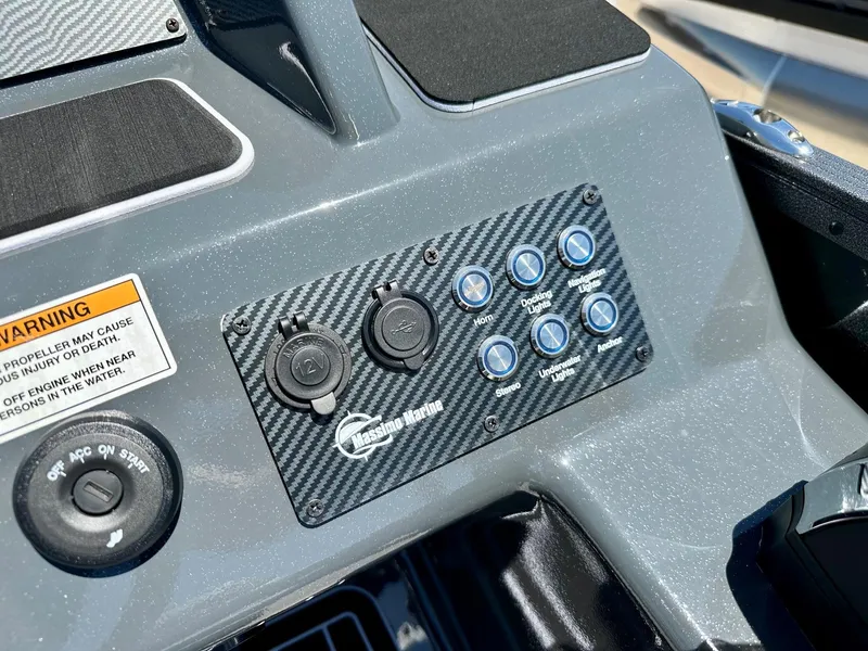 Slide: The Image of Control panel of 2024 Massimo Marine P24-Limited Max boat with warning label and switches. - 13