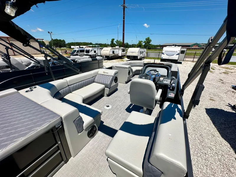 Slide: The Image of 2024 Massimo Marine P24-Limited Max pontoon boat with spacious seating and modern dashboard. - 6