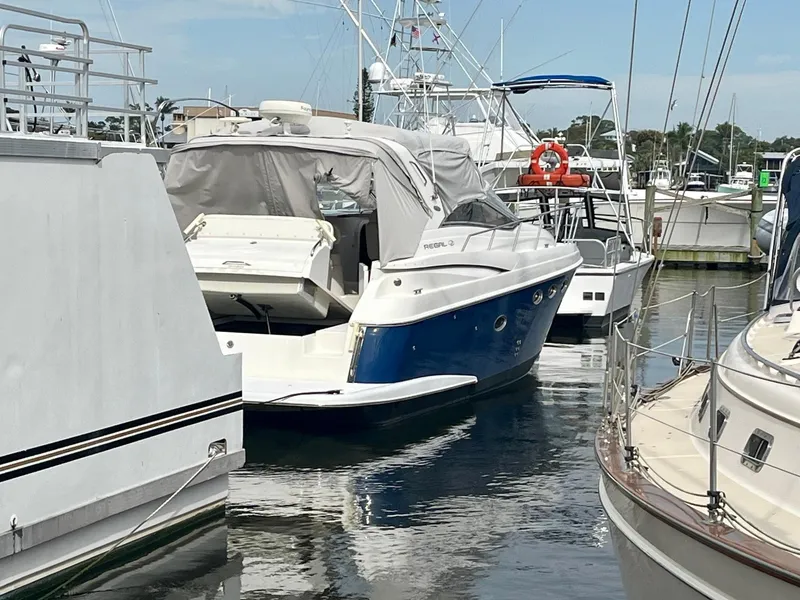 Slide: The Image of 2003 Regal Commodore 3860 yacht docked at a marina. - 1