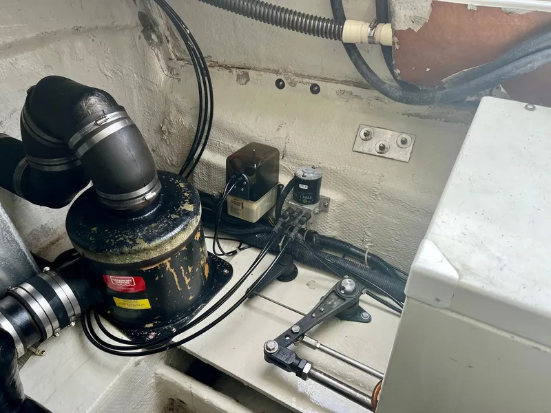 Slide: The Image of Engine compartment of a 2003 Regal Commodore 3860 boat with various mechanical components. - 11