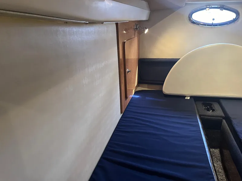 Slide: The Image of Interior cabin of a 2003 Regal Commodore 3860 yacht with blue bedding. - 18