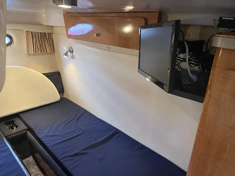 Slide: The Image of Interior cabin of 2003 Regal Commodore 3860 with bed, TV, and storage. - 19