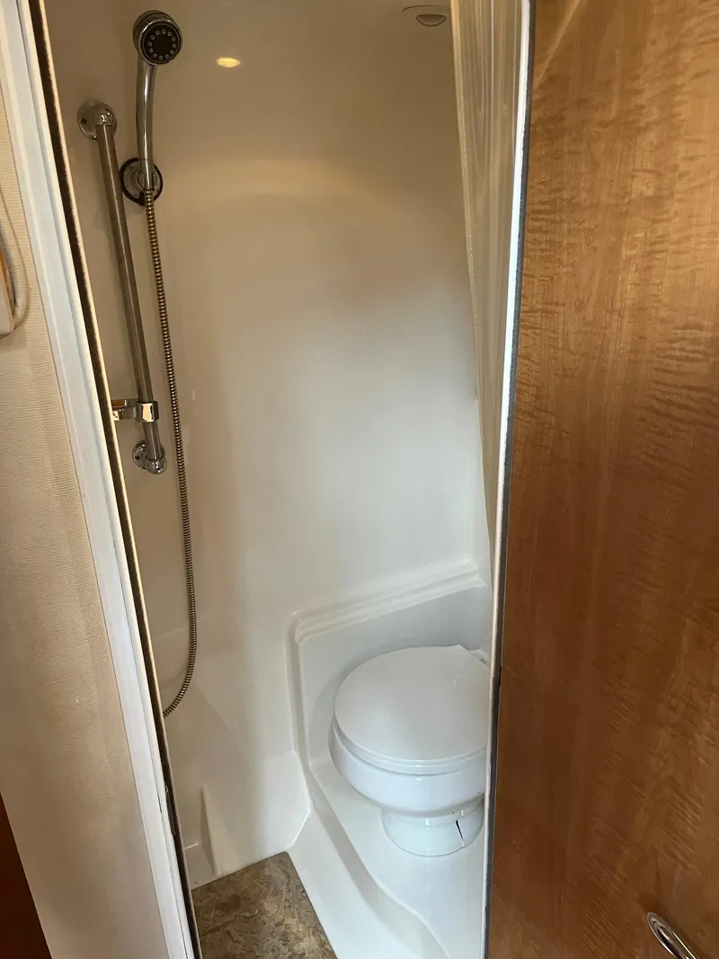 Slide: The Image of Compact bathroom with shower and toilet in 2003 Regal Commodore 3860 yacht. - 22