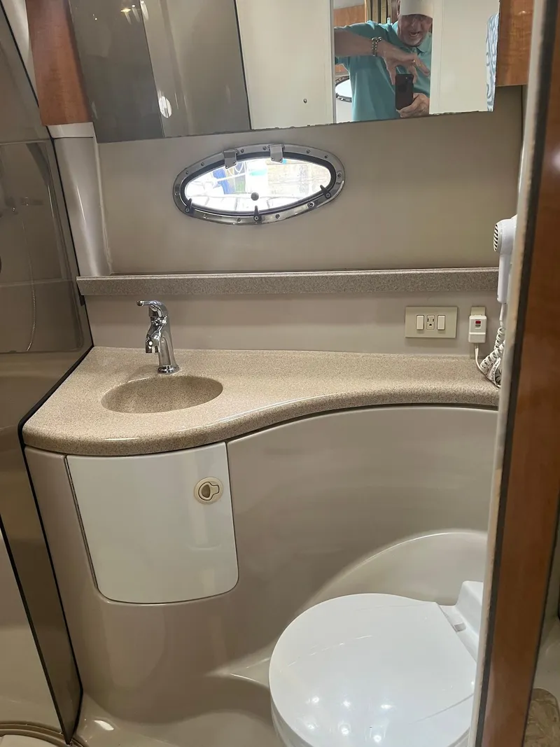 Slide: The Image of 2003 Regal Commodore 3860 bathroom with sink, mirror, and toilet. - 24