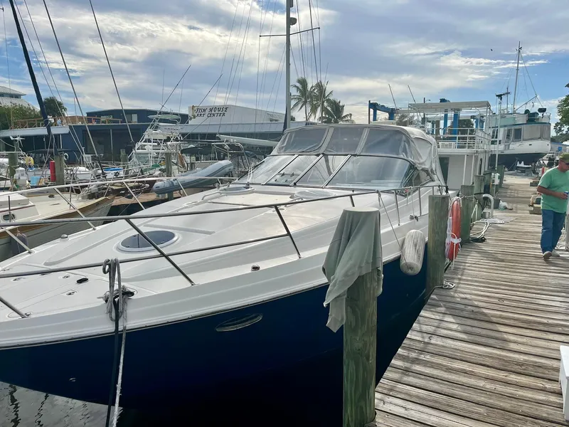 Slide: The Image of 2003 Regal Commodore 3860 yacht docked at a marina. - 3