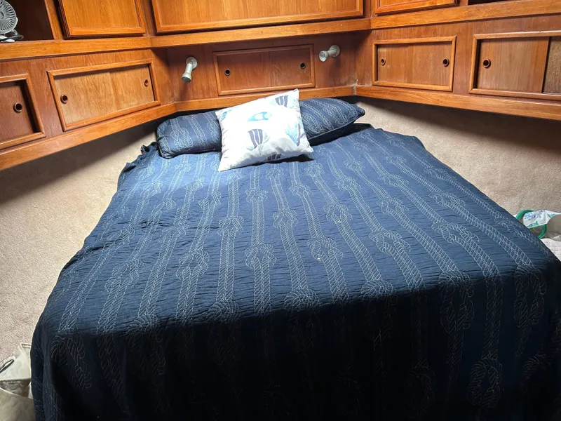 Slide: The Image of Cozy cabin bed in 1990 Egg Harbor 42 Golden Egg yacht with wooden storage cabinets. - 11