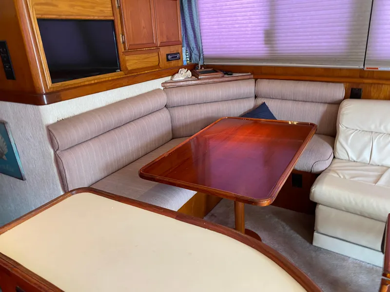 Slide: The Image of Interior of 1990 Egg Harbor 42 Golden Egg yacht with wood table and cushioned seating. - 2