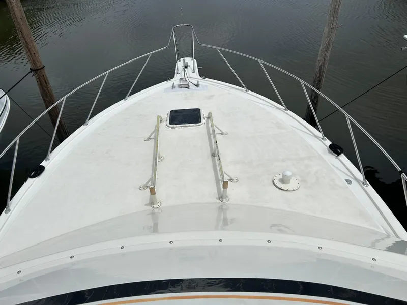 Slide: The Image of Bow view of 1990 Egg Harbor 42 Golden Egg yacht, docked on calm water. - 29