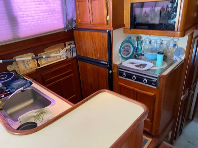 Slide: The Image of 1990 Egg Harbor 42 Golden Egg yacht kitchen with wooden cabinetry and appliances. - 4