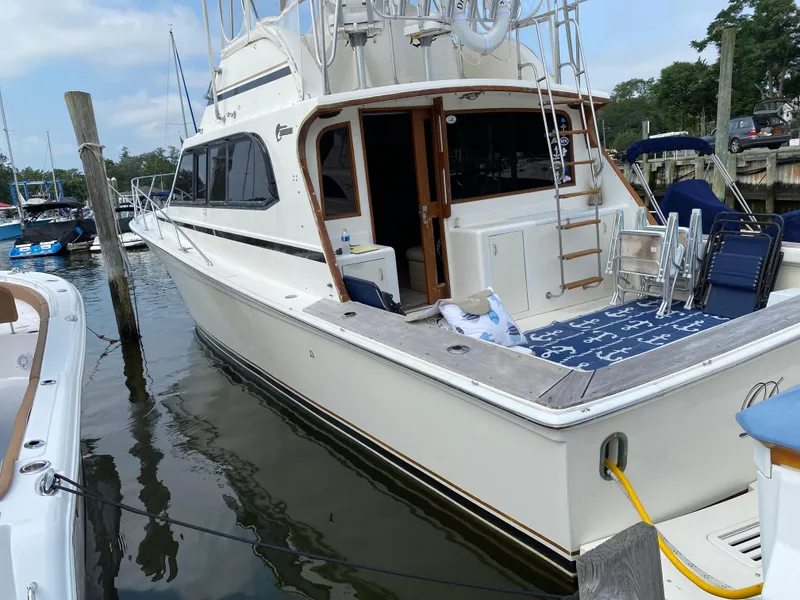 Slide: The Image of 1990 Egg Harbor 42 Golden Egg yacht docked at marina, featuring spacious deck and classic design. - 8