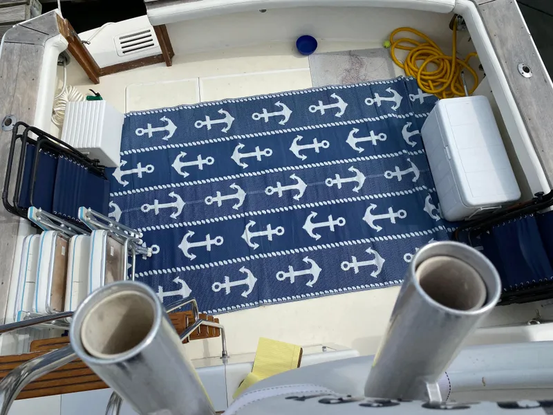 Slide: The Image of Deck of 1990 Egg Harbor 42 Golden Egg with anchor-patterned rug and seating. - 9