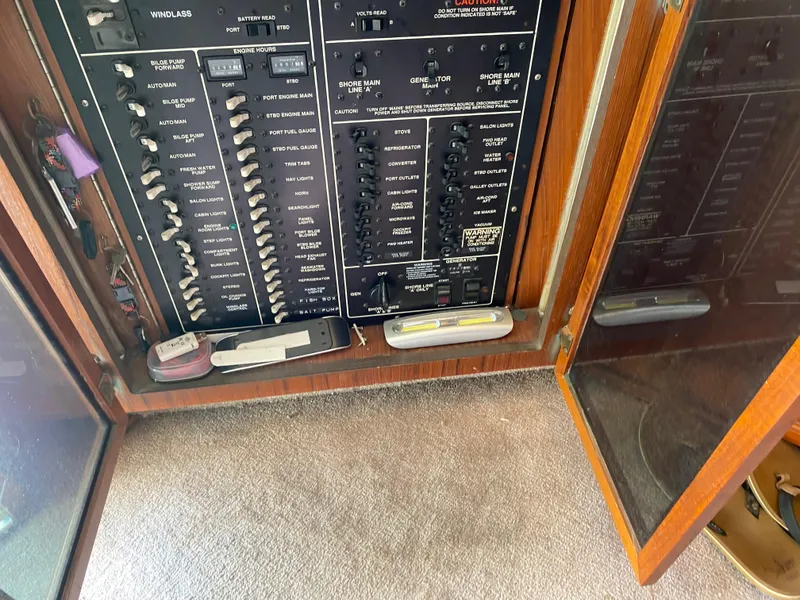 Slide: The Image of Electrical panel inside a 1990 Egg Harbor 42 Golden Egg yacht, featuring various switches and controls. - 13