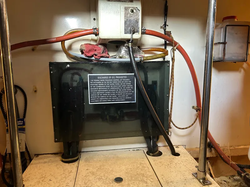 Slide: The Image of Engine room of 1990 Egg Harbor 42 Golden Egg with oil discharge warning sign. - 14