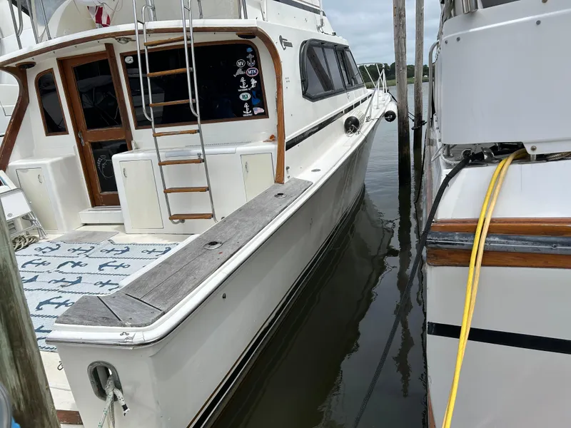 Slide: The Image of 1990 Egg Harbor 42 Golden Egg yacht docked, featuring wooden accents and nautical decor. - 20