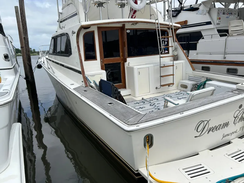 Slide: The Image of 1990 Egg Harbor 42 Golden Egg yacht docked, featuring a spacious deck and elegant design. - 21