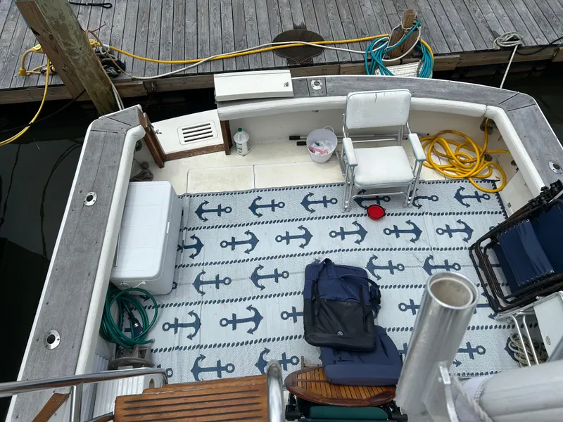 Slide: The Image of Bow view of 1990 Egg Harbor 42 Golden Egg yacht, docked on calm water. - 24