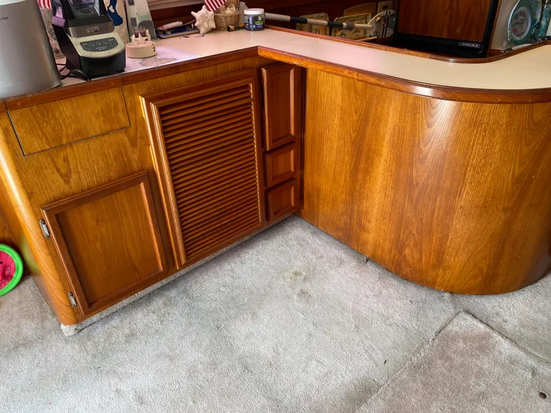 Slide: The Image of 1990 Egg Harbor 42 Golden Egg yacht kitchen with wooden cabinetry and appliances. - 5