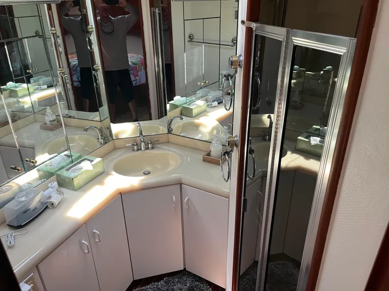 Slide: The Image of 1989 Viking 57 Convertible bathroom with mirrored vanity and shower. - 10
