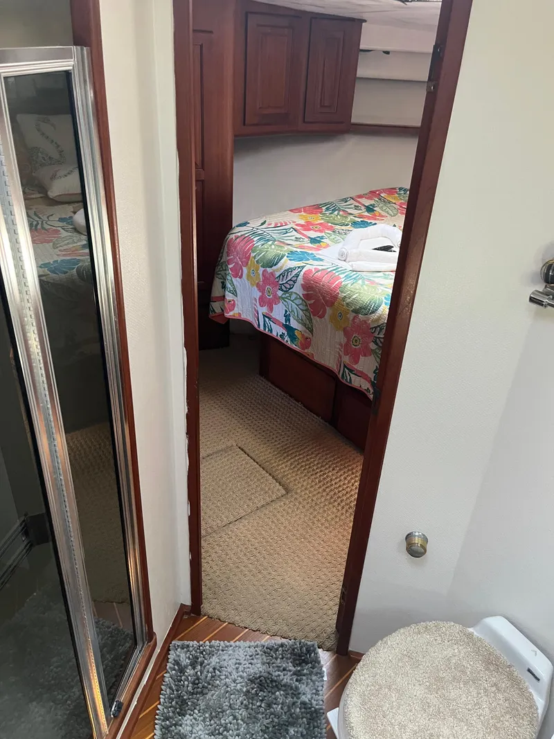 Slide: The Image of 1989 Viking 57 Convertible interior with bedroom and bathroom view. - 11