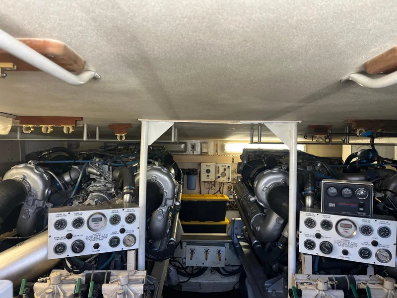 Slide: The Image of Engine room of a 1989 Viking 57 Convertible yacht with dual engines and control panels. - 12