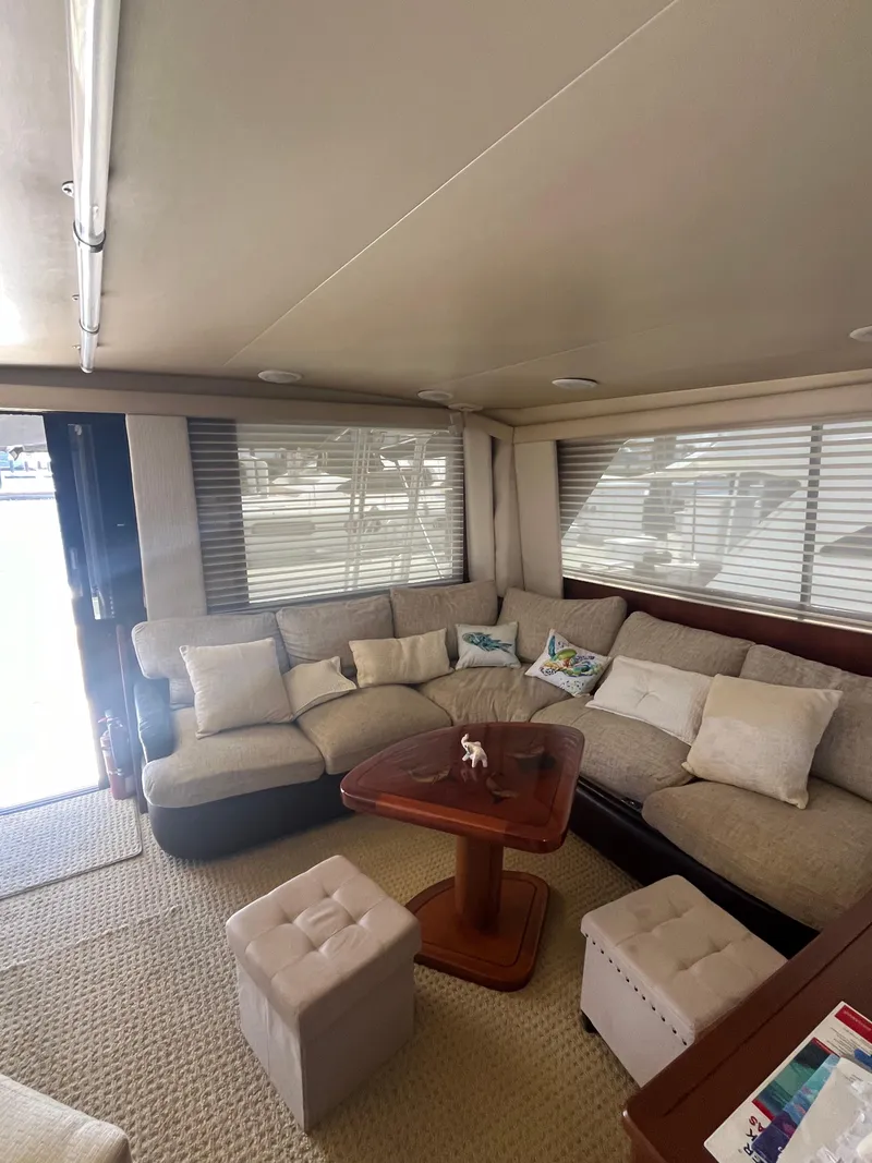 Slide: The Image of 1989 Viking 57 Convertible yacht interior with cozy seating area and wooden table. - 5