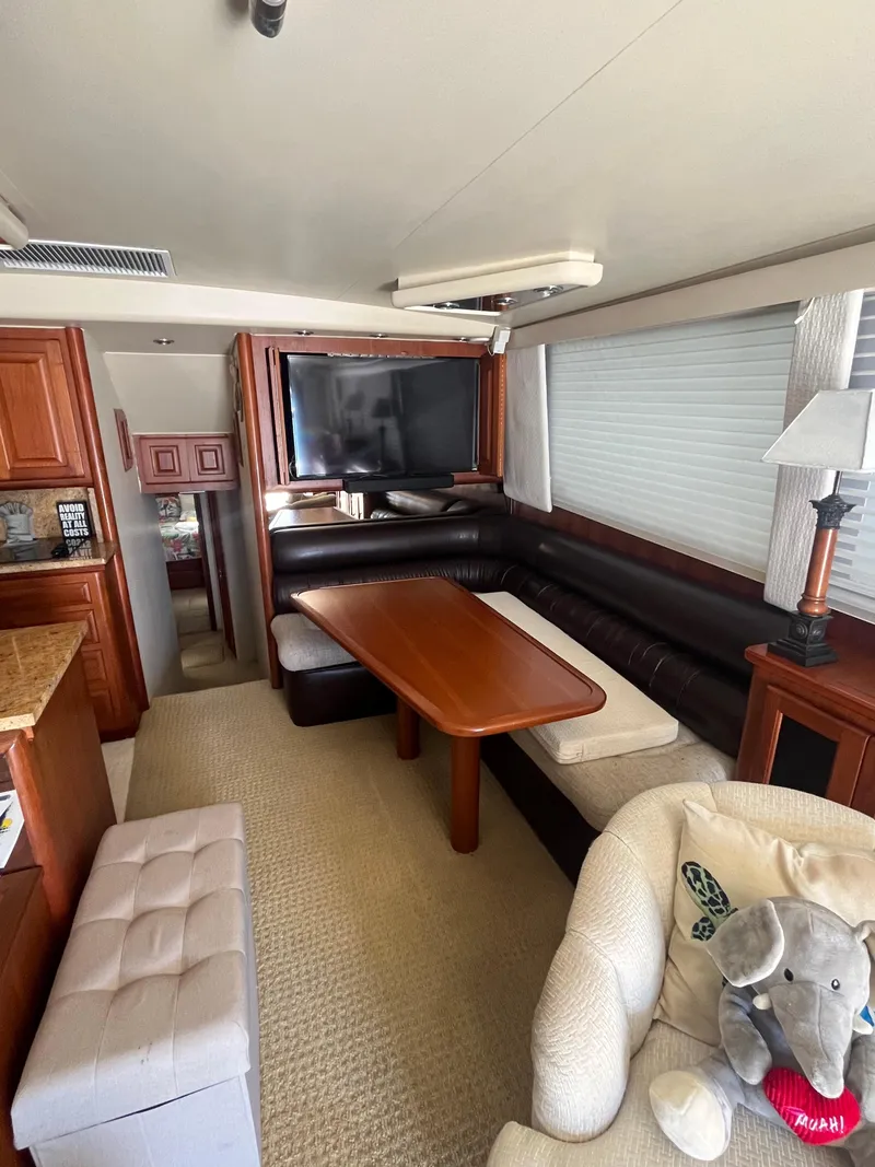 Slide: The Image of 1989 Viking 57 Convertible yacht interior with dining area and TV. - 6