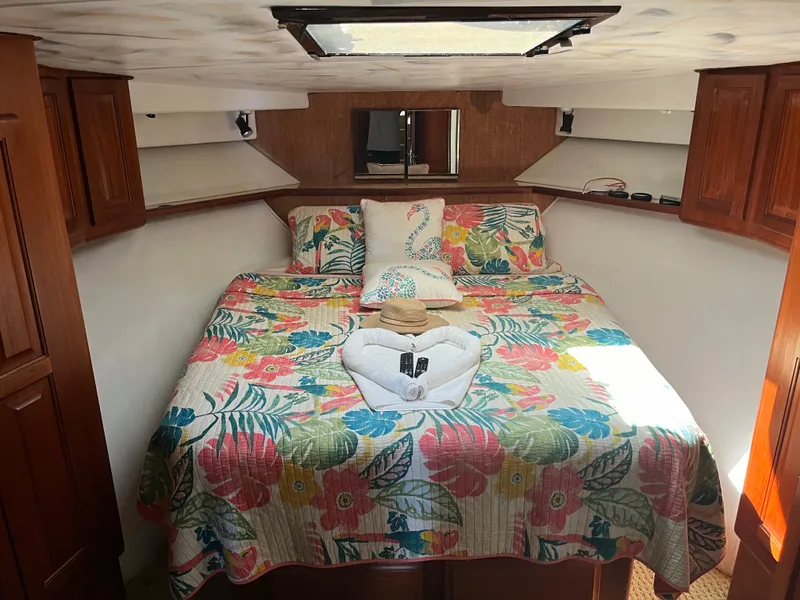 Slide: The Image of Cozy bedroom in 1989 Viking 57 Convertible boat with floral bedding and wooden cabinets. - 9