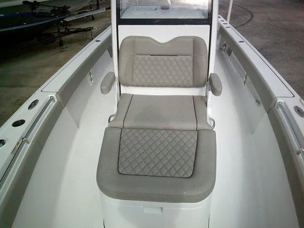 Slide: The Image of 2024 Sportsman 267OE boat interior seating with cushioned bench and armrests. - 10