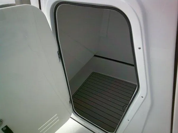 Slide: The Image of 2024 Sportsman 267OE storage compartment with open door. - 12