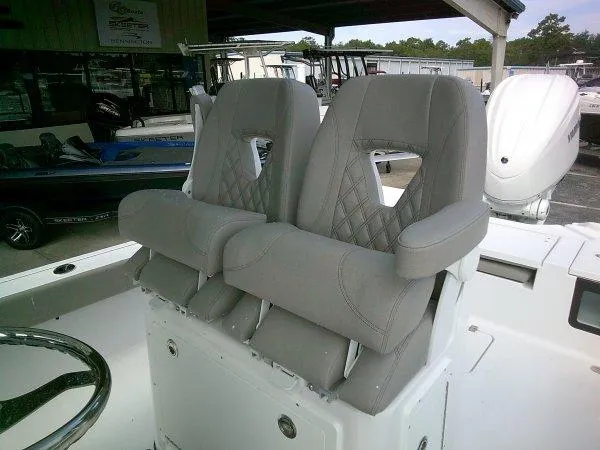 Slide: The Image of 2024 Sportsman 267OE boat with dual gray captain's chairs and armrests. - 14