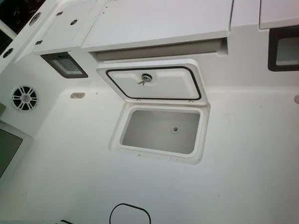 Slide: The Image of 2024 Sportsman 267OE boat deck with storage compartments and speaker. - 15