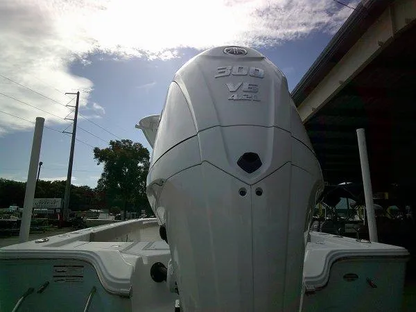 Slide: The Image of 2024 Sportsman 267OE boat with 300 V6 engine under a partly cloudy sky. - 19