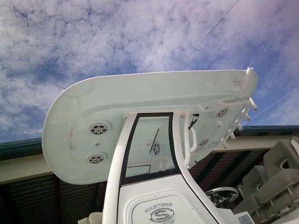 Slide: The Image of 2024 Sportsman 267OE boat console and T-top against a cloudy sky. - 21