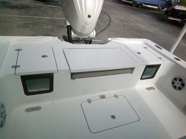 Slide: The Image of 2024 Sportsman 267OE boat stern with storage compartments and outboard motor. - 4