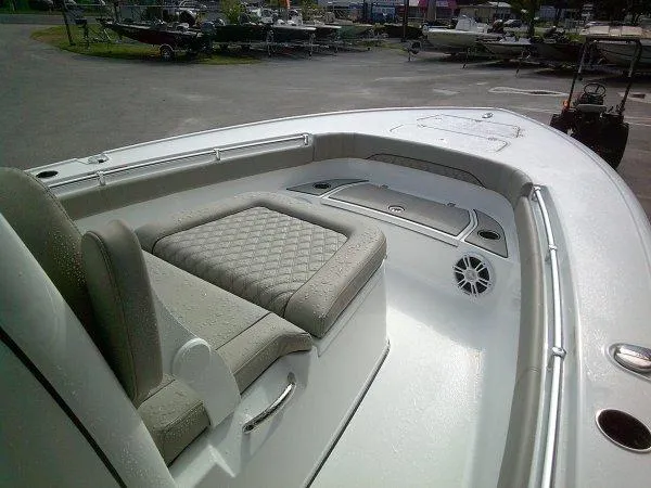 Slide: The Image of 2024 Sportsman 267OE boat interior with cushioned seating and storage compartments. - 7