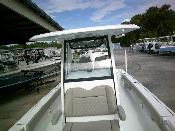 Slide: The Image of 2024 Sportsman 267OE boat at a marina, front view. - 9