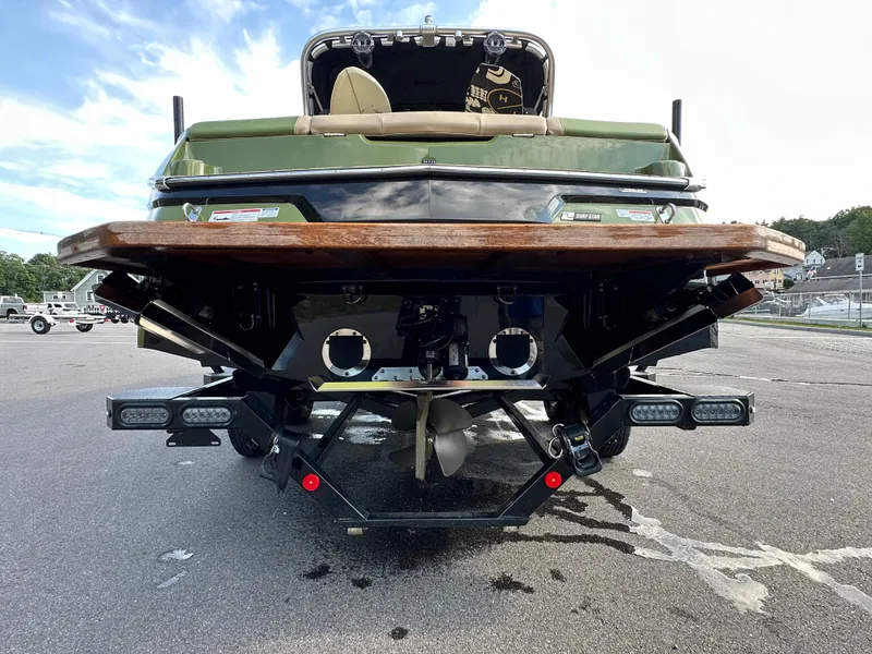 Slide: The Image of 2023 MasterCraft NXT 22 boat rear view with propeller and swim platform. - 13