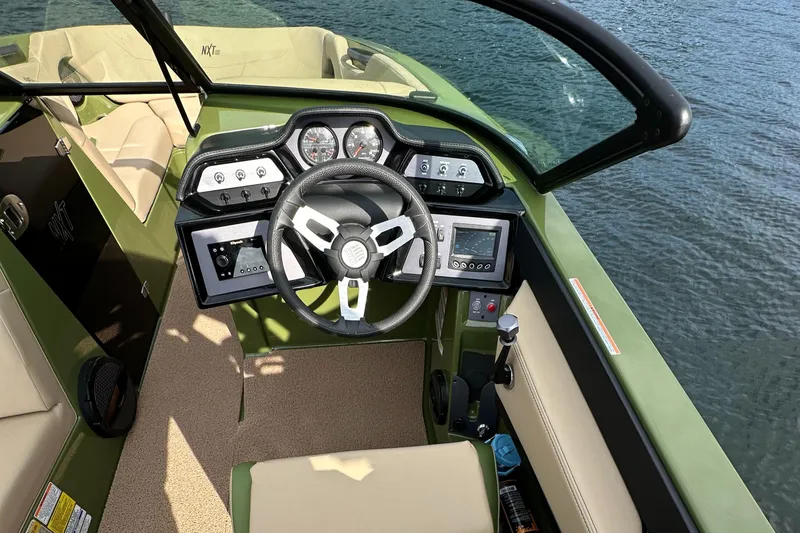 Slide: The Image of 2023 MasterCraft NXT 22 boat dashboard with steering wheel and control panels. - 20