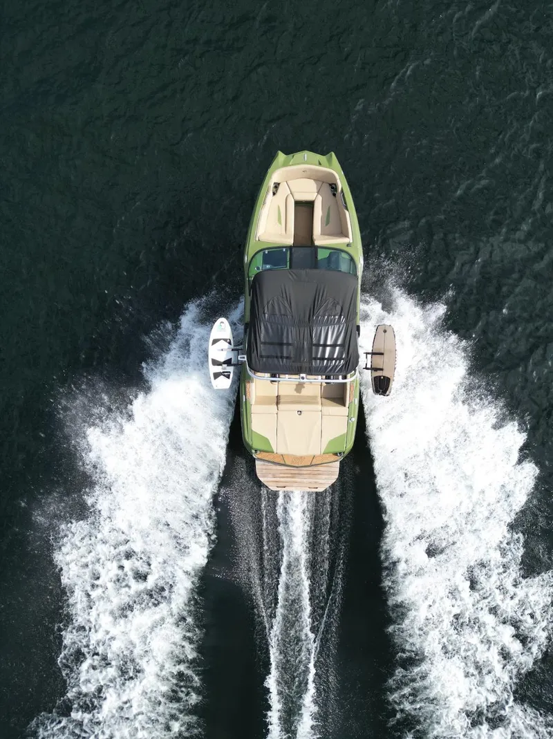 Slide: The Image of Aerial view of 2023 MasterCraft NXT 22 boat cruising on water. - 32