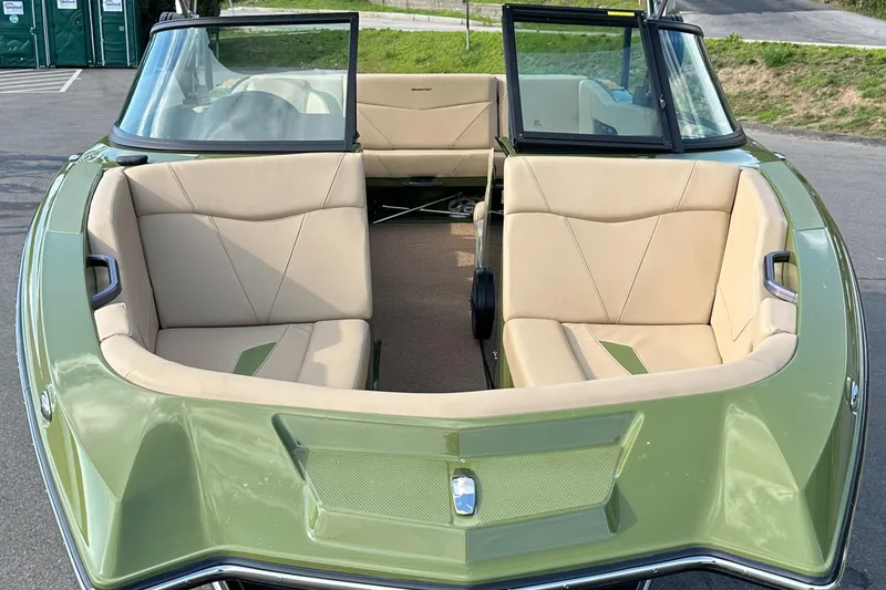 Slide: The Image of 2023 MasterCraft NXT 22 boat with beige interior and green exterior. - 5