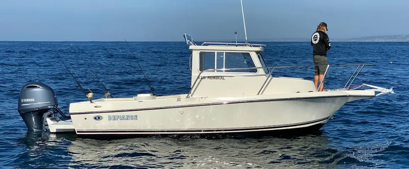 The Image of 2025 Defiance Admiral 220 EX boat on open water with person fishing. - 1