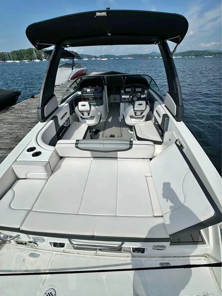 Slide: The Image of 2019 Chaparral 257 SSX boat with spacious seating and sleek design on a sunny day. - 3
