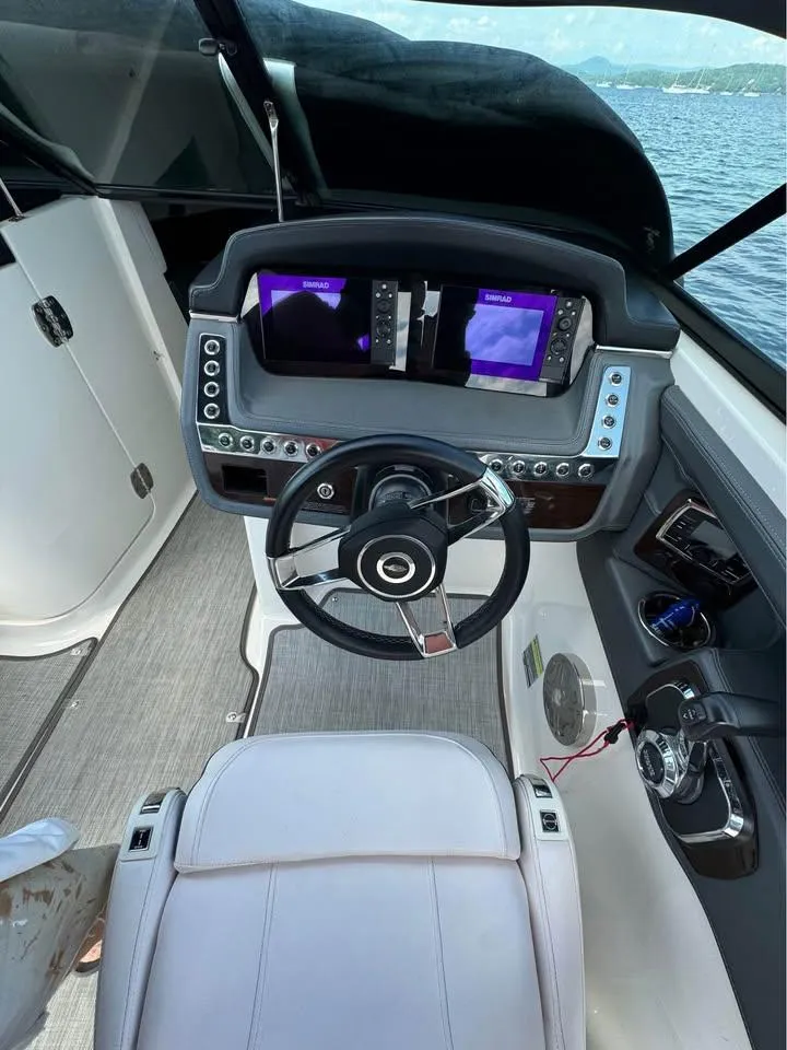 Slide: The Image of 2019 Chaparral 257 SSX boat cockpit with modern steering and dual displays. - 8