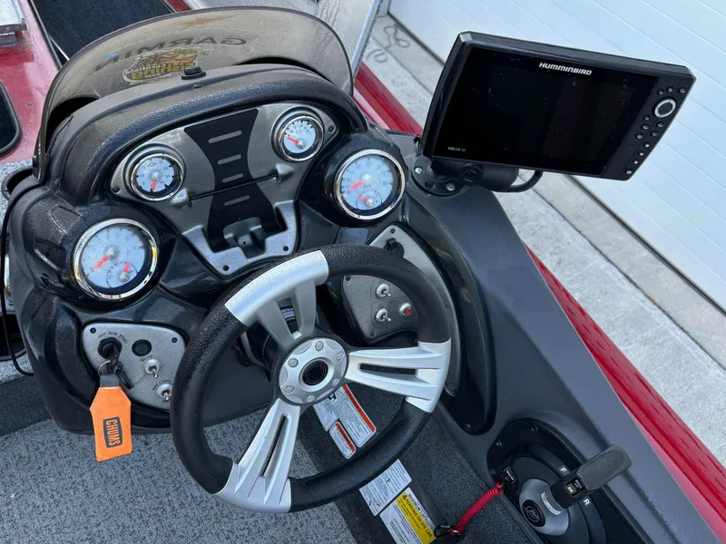 Slide: The Image of 2020 Tracker Pro Team 195 TXW Tournament Edition boat dashboard with steering wheel and fishfinder. - 10