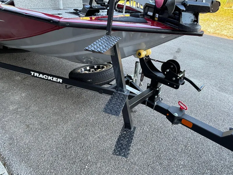 Slide: The Image of 2020 Tracker Pro Team 195 TXW Tournament Edition boat on trailer with step ladder. - 2
