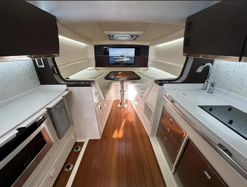Slide: The Image of Luxurious 2019 Grady-White Canyon boat interior with modern kitchen and wood flooring. - 11