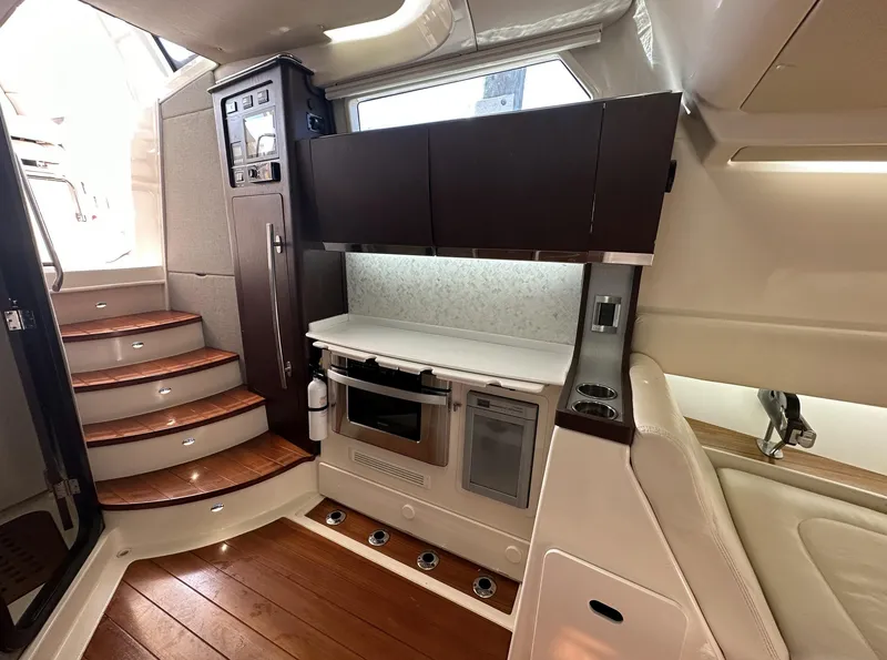 Slide: The Image of 2019 Grady-White Canyon boat interior with modern kitchen and wooden flooring. - 12