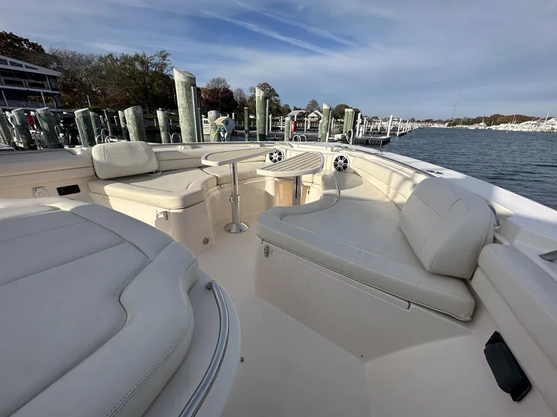 Slide: The Image of 2019 Grady-White Canyon boat interior with plush seating and waterfront view. - 13