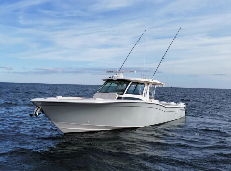Slide: The Image of 2019 Grady-White Canyon boat on open sea under blue sky. - 3