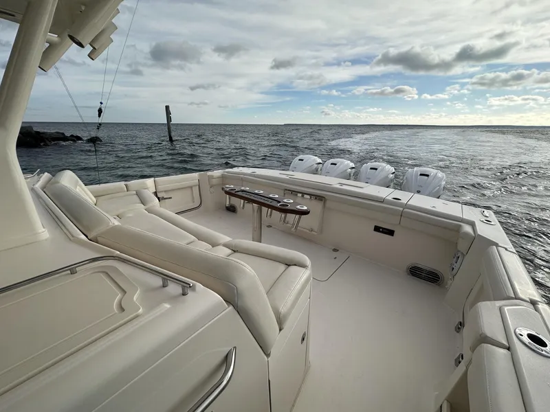 Slide: The Image of 2019 Grady-White Canyon boat with spacious deck and multiple outboard engines on open water. - 4